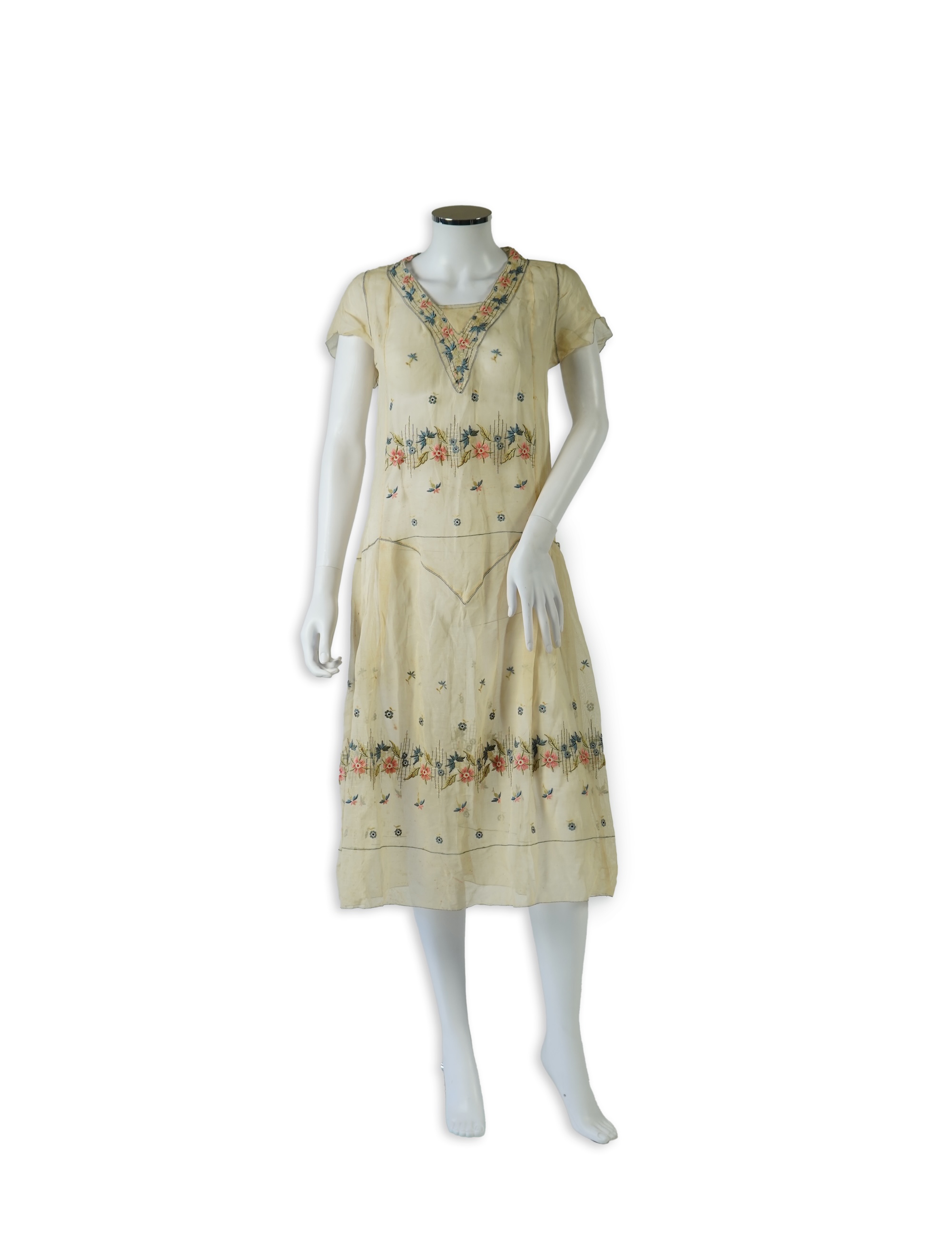 An unusual 1920's fine cream lawn summer dress with hand embroidered blue, pink, flowers, tie and picot edging., 116cm long. Condition - some small rust stains and one small tear at the back right shoulder.